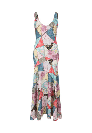 A sleeveless, V-neck maxi dress featuring a colorful geometric patchwork print with triangles and abstract shapes in pink, blue, yellow, beige, and black, shown against a plain white background.